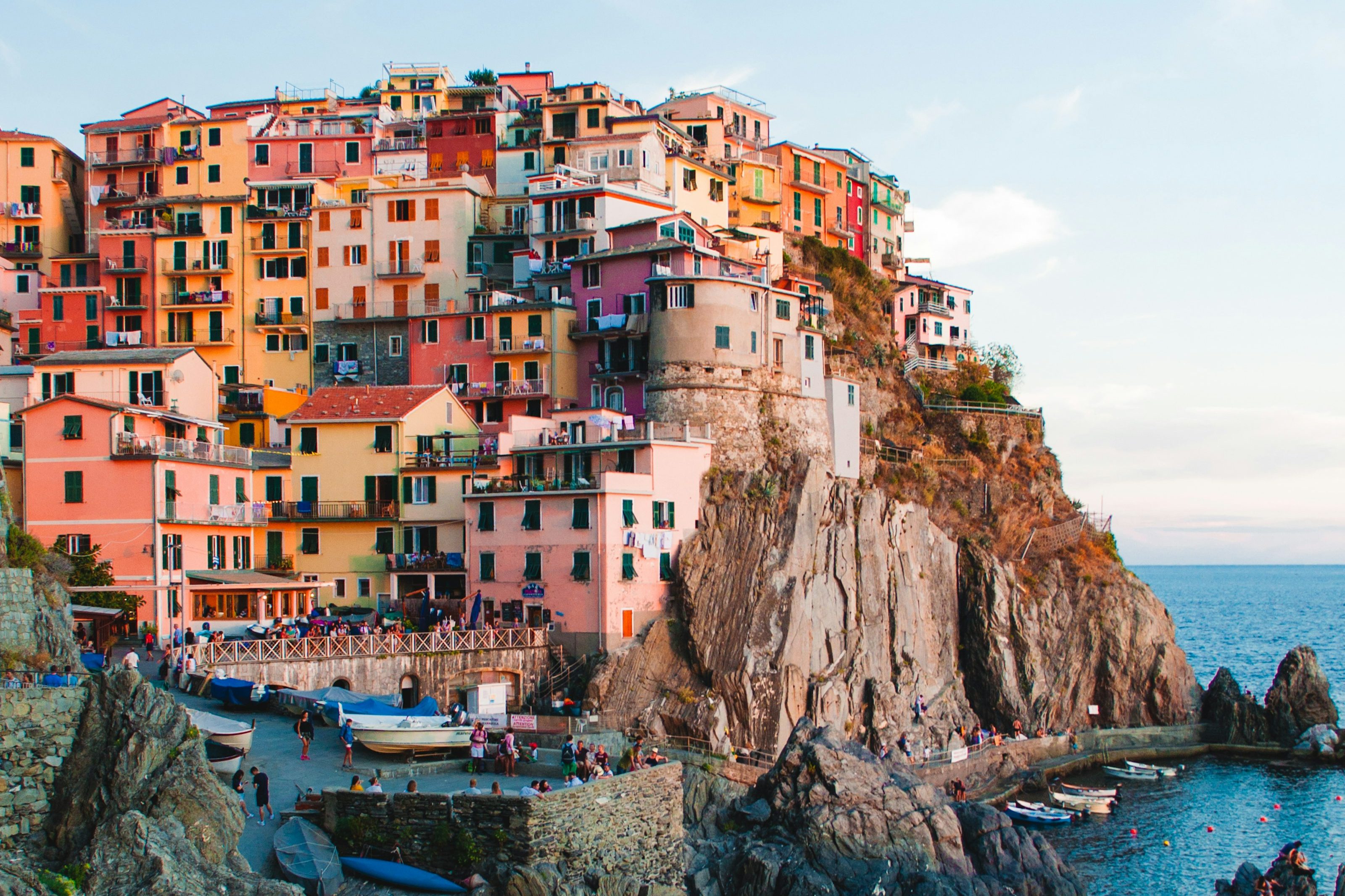 Pastel houses stacked on the cliff above the harbour at Manarola, Cinque Terre
